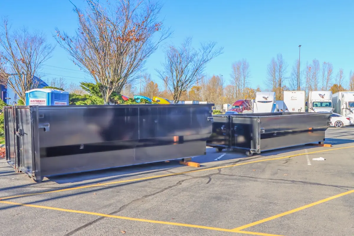 Professional dumpster rental service with roll-off container on residential driveway in Fort Knox